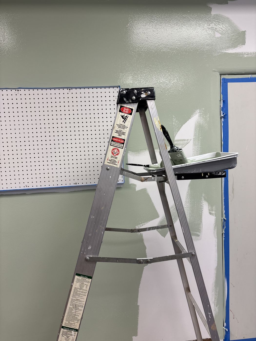 Fresh sage-green paint going up in the program room