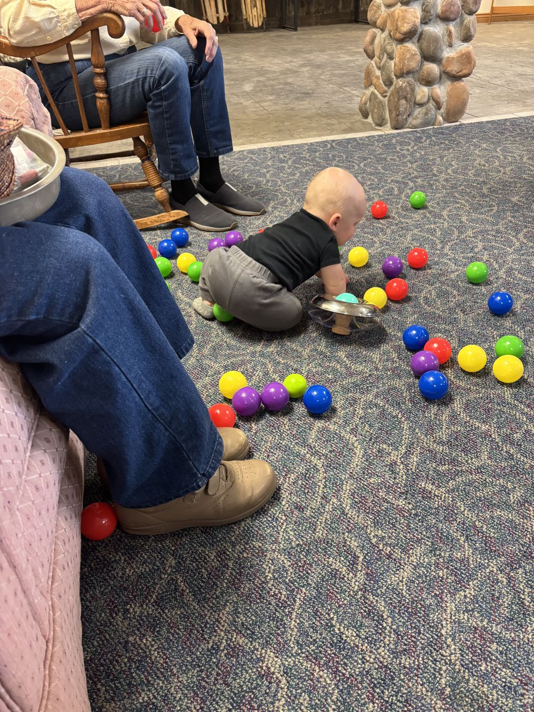 Playing with colorful balls in the activity room at Papa's Place Colorado